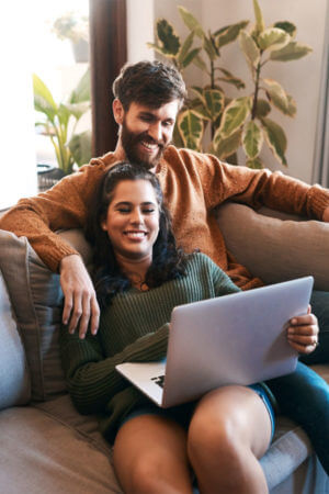 Couple at home using labtop